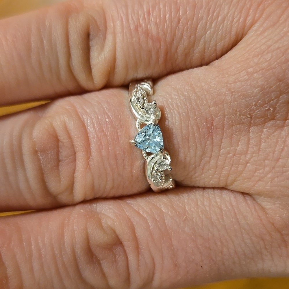 Light blue triangle stone with swirls and diamond accents